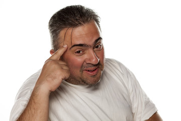 fat smiling man holding a finger to his forehead