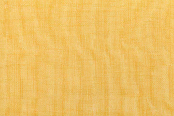 Light yellow ocher background from a textile material. Fabric with natural texture. Backdrop.