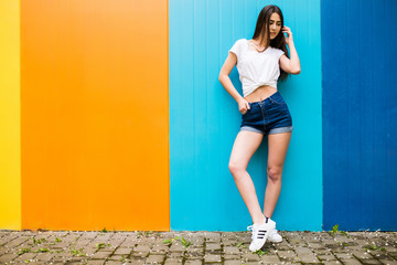 Young beuty girl with nice body against color wall background
