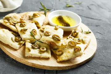 Homemade pizza with olives and olive oil