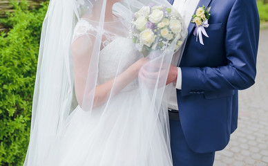 Elegant bride and groom posing together outdoors on a wedding day