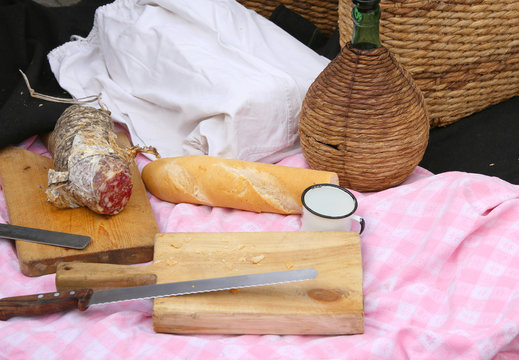 picinc with salami, fragrant bread and big knife and flask