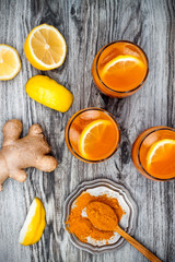 Obraz na płótnie Canvas Carrot ginger immune boosting, anti inflammatory lemonade with turmeric and honey. Detox morning juice drink, clean eating