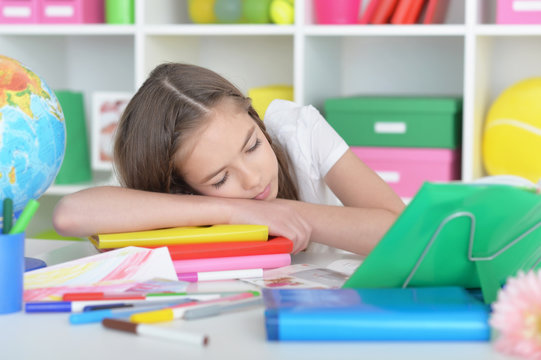student girl sleeping on books