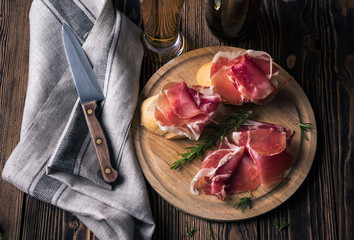 Spanish tapas with jamon on a wooden background