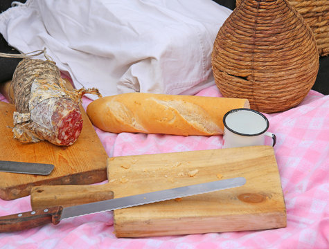 picinc with salami, big knife and sandwiches