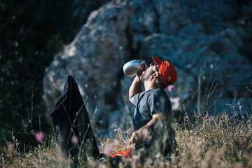 Backpacker drinking water from flask