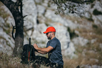 Climber preparing backpack for travelling