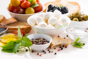 fresh ingredients for salad with mozzarella on white table