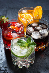 iced fruit drinks on a dark background, top view