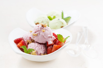 strawberry and pistachio ice cream on white table