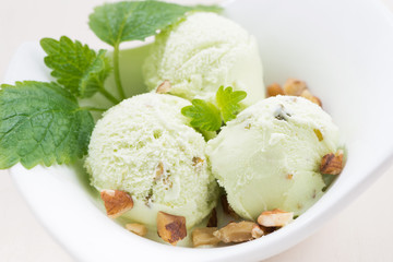 pistachio ice cream in a bowl, closeup