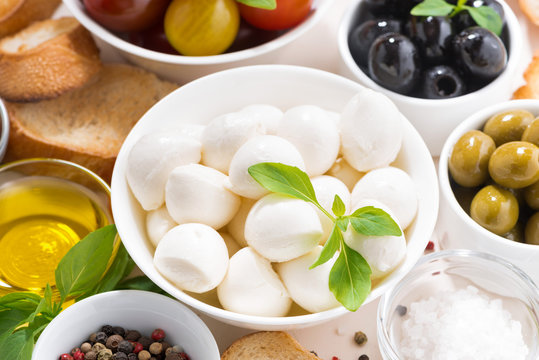 fresh ingredients for salad with mozzarella on white table