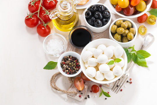 ingredients for salad with mozzarella on white background