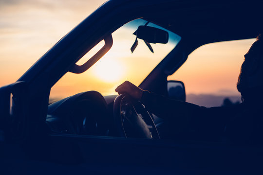 Driver Watching Sunset From Car