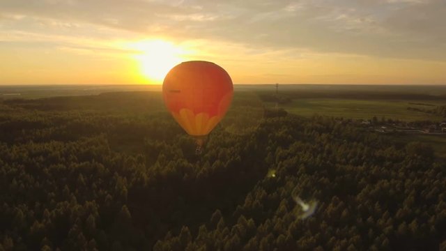 Hot air balloons in the sky over a field in the countryside.Aerial view:Hot air balloons in the sky over a field in the countryside in the beautiful sky and sunset.Aerostat fly in the countryside. 4K