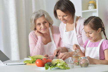 women with little girl cooking