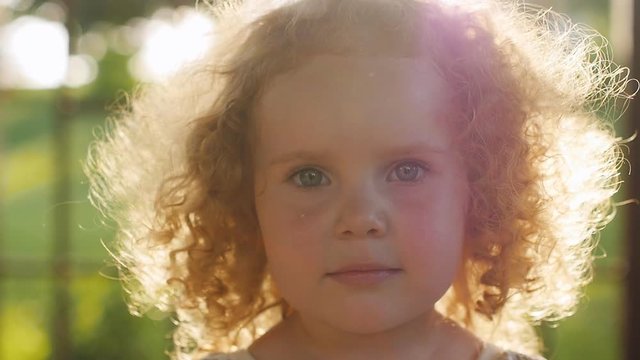 Portrait of beautiful curly girl in sunset light