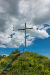 wooden cross and partly cloudy sky