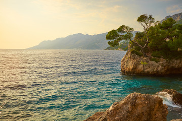 Obraz premium Rock island at sunset in small mediterranean town Brela , Croati