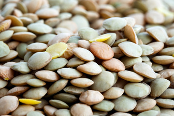 Detail background of green uncooked lentils in perspective.