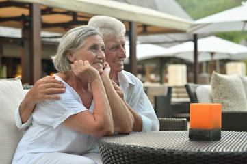 Amusing old couple at cafe table