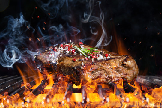 Delicious grilled beef steak on a barbecue grill.