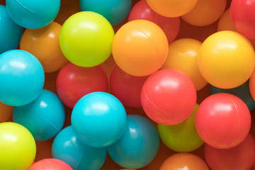 Fototapeta na wymiar Bright and Colorful toy balls, kids ball pit background, softpla