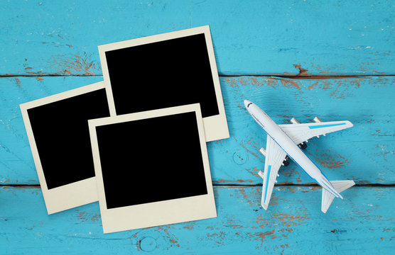 Top view of travel instant photographs next to airplane