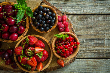 Selection of colorful berries on rustic background
