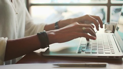 Young woman freelancer typing on laptop