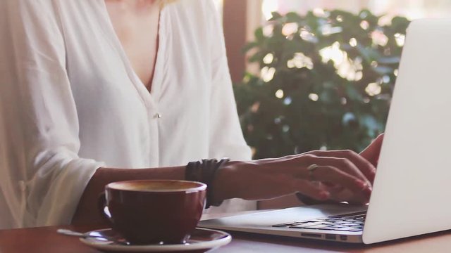 Young woman freelancer typing on laptop - Powered by Adobe