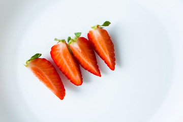 Ripe red strawberries on a plate.