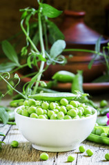 Grains and pods of green peas, vintage wooden background, select