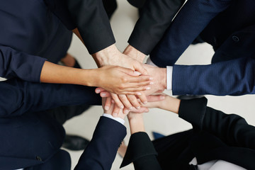 Business concept - group of business people joining hands