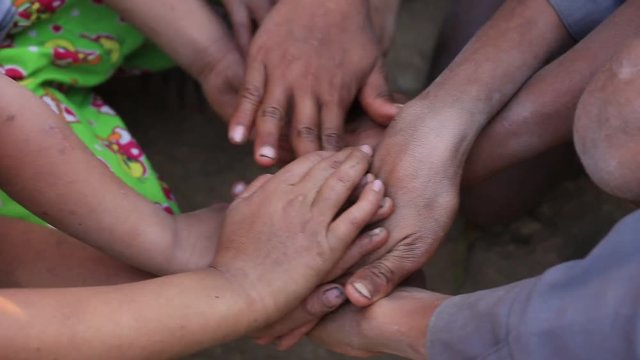 Many connecting poor children's hands. Mrauk-U, Myanmar