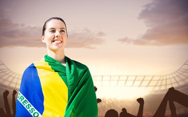 Naklejka premium Composite image of sporty woman holding brazilian flag