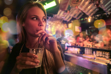 Girl at the club drinking a cocktail