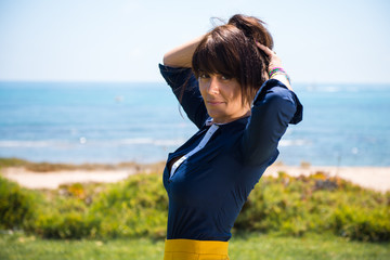 Fototapeta premium Beautiful woman posing in a park in from the beach