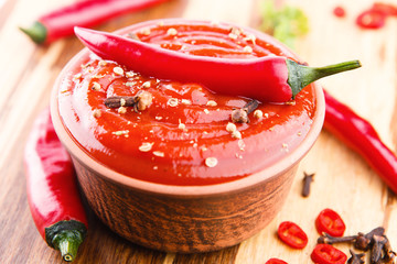 Red hot chilli sauce on wooden background
- 114060164