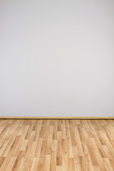 copyspace background with an empty white wall with a hardwood wooden floor