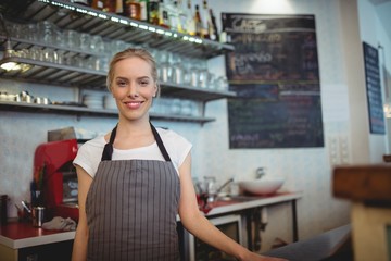 Portrait of confident barista at coffee shop