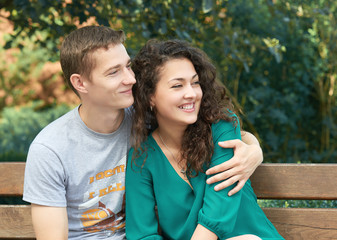 Romantic couple posing in city park, summer season, lovers boy and girl