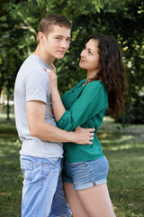Romantic couple posing in city park, summer season, lovers boy and girl