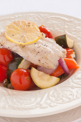Fish Provencal a seafood dish of roasted mediterranean vegetables and white fish 