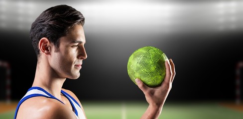 Composite image of confident athlete man holding a ball 