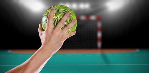 Composite image of sportsman holding a ball