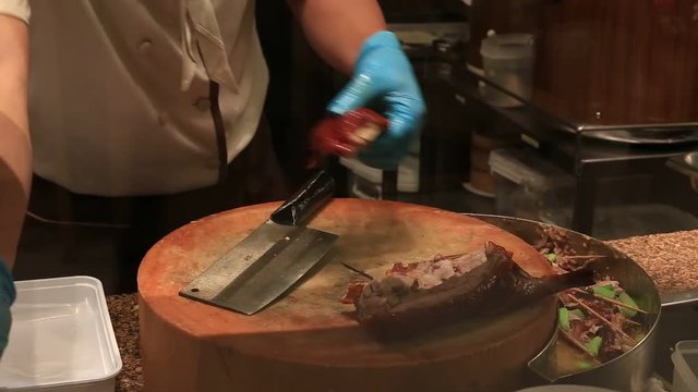 Chef prepares peking roast duck in a restaurant in Siam Paragon Mall. Bangkok, Thailand. With 300,000 sq m of retail space Siam Paragon is one of the world's largest malls