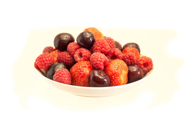 Fresh berries on the dish, raspberries, strawberries, cherries