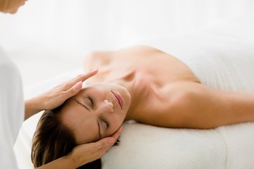 Fototapeta na wymiar Cropped image of masseur giving massage to woman